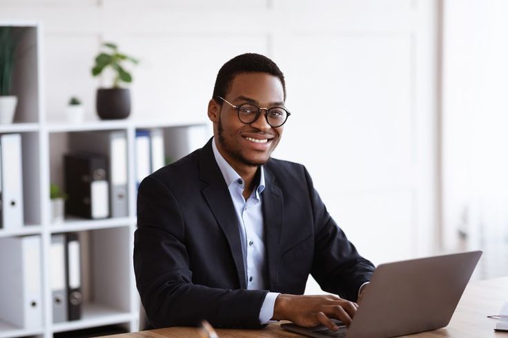 A cheerful man working on his laptop