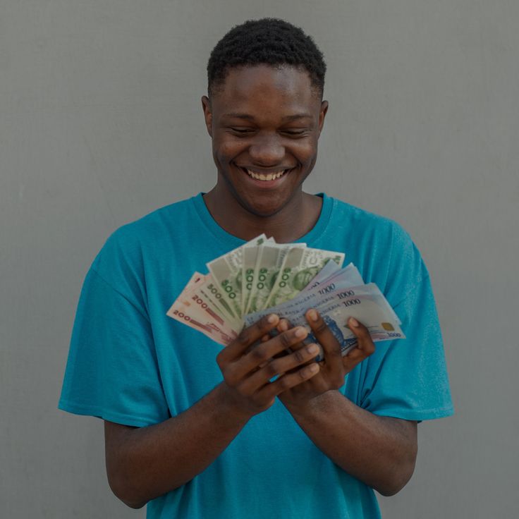 A man holding Naira notes